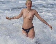 Miley Cyrus Tattoos and Topless at the Beach In Hawaii