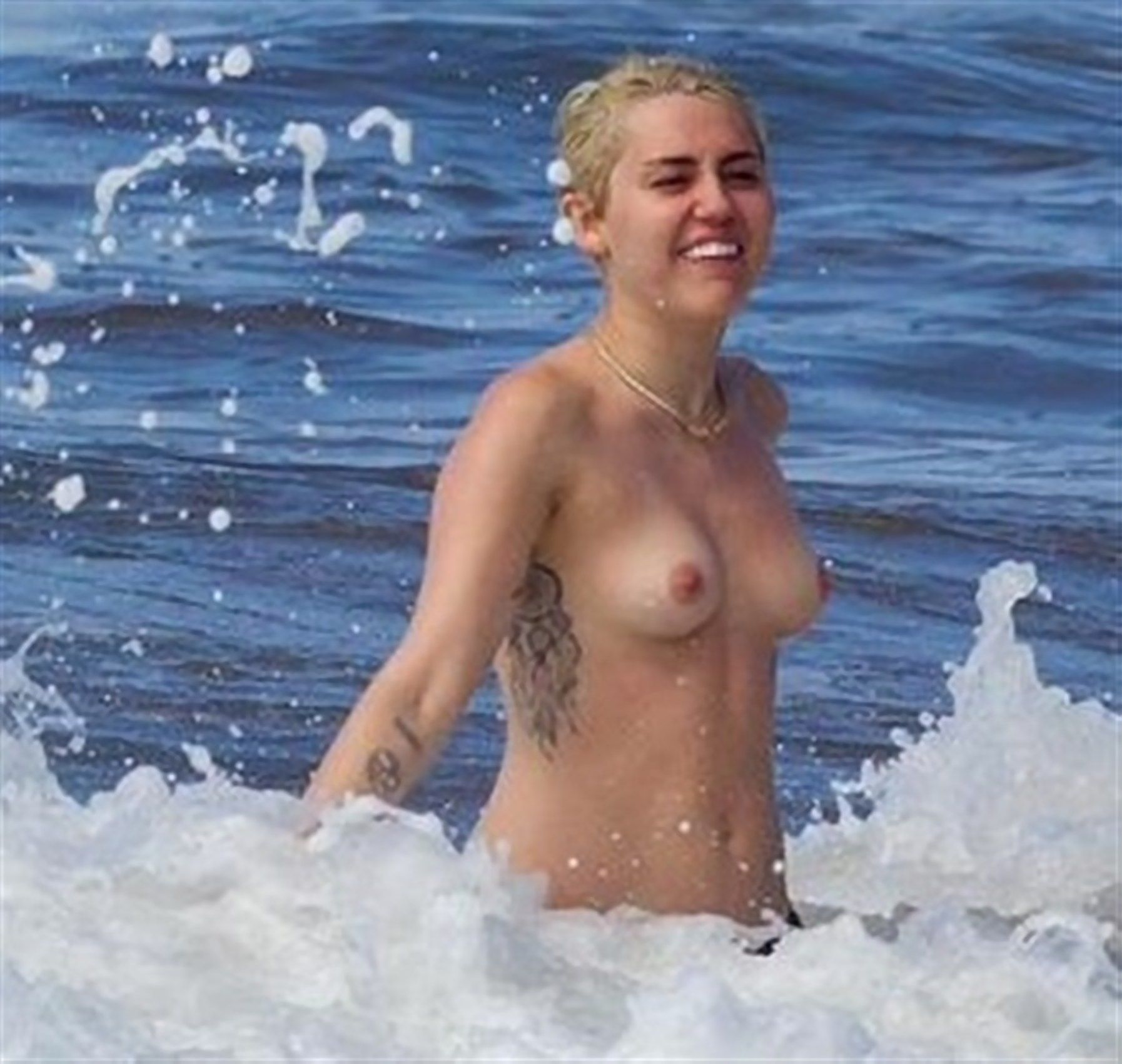 Miley Cyrus Tattoos and Topless at the Beach In Hawaii