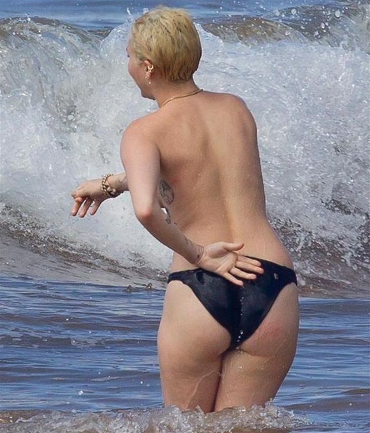 Miley cyrus tattoos and topless at the beach in hawaii