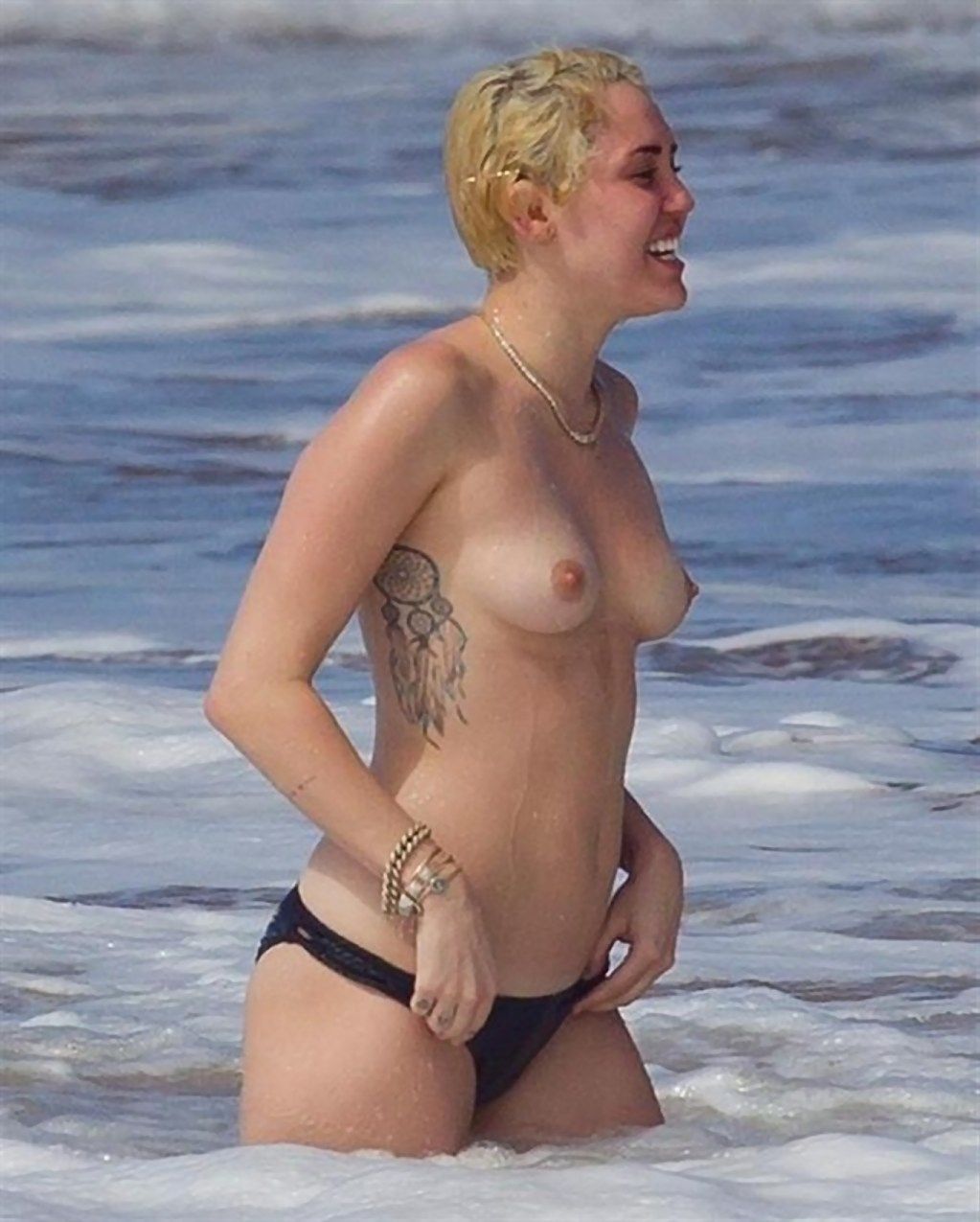 Miley cyrus tattoos and topless at the beach in hawaii